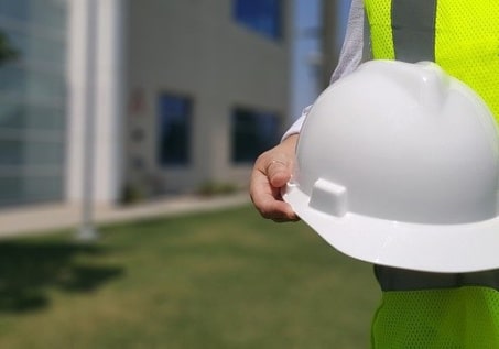 person holding a hard hat
