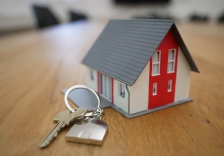 small wooden house on a key chain