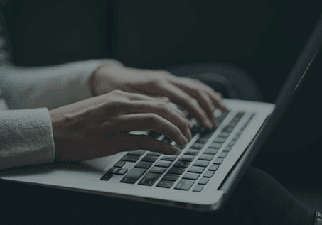 hands typing on a laptop