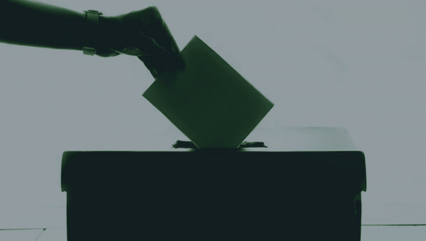 ballot box with someone placing their voting card