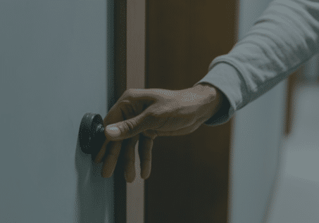 person ringing a doorbell