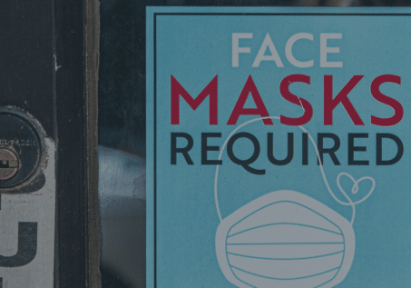 shop door with sign that says "face masks required"