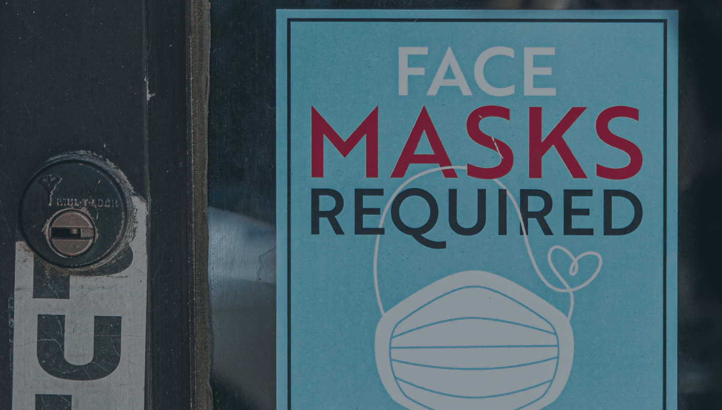 shop door with sign that says "face masks required"